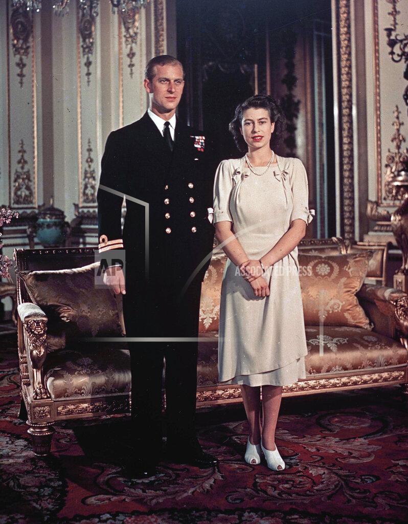 Uncredited FILE - Britain's Princess Elizabeth in a light-colored dress with sleeves above the elbow and peekaboo low heels, appears with Lt. Philip Mountbatten for a photo in London in September 1947. (AP Photo, File)