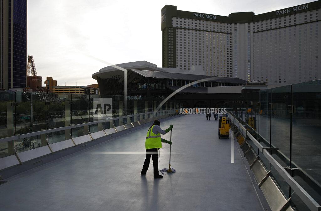 John Locher FILE - In this March 31, 2020, file photo, a worker cleans along the Las Vegas Strip devoid of the usual crowds as casinos and other business are shuttered due to the coronavirus outbreak in Las Vegas. The coronavirus pandemic has been particularly brutal to the tourism-dependent economies of Nevada and Hawaii, lifting the unemployment rate in both states to about one-quarter of the workforce. (AP Photo/John Locher, File)
