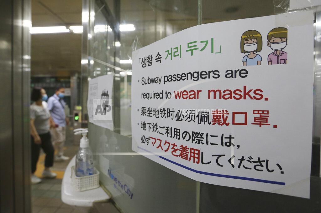 Ahn Young-Joon A notice on precautions against the new coronavirus is displayed at a subway station in South Korea, Monday, June 22, 2020. The sign at top reads: "Social distance." (AP Photo/Ahn Young-joon)