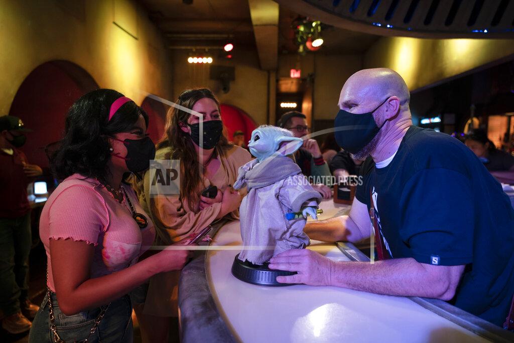 Jae C. Hong Bartender Guy Klender, right, shares a light moment with customers while celebrating Star Wars Day at Scum and Villainy Cantina, a bar located on Hollywood Blvd, in Los Angeles, Tuesday, May 4, 2021. California has the lowest infection rate in the country. Los Angeles County, which is home to a quarter of the state's nearly 40 million people and has endured a disproportionate number of the state's 60,000 deaths, didn't record a single COVID-19 death Sunday or Monday, which was likely due to incomplete weekend reporting but still noteworthy. (AP Photo/Jae C. Hong)