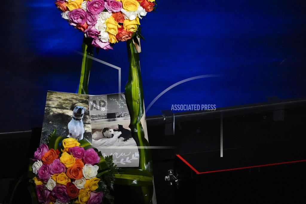 Rebecca Blackwell Pictures of Gonzalez family pets also lost in the disaster are displayed next to flowers at the funeral of Edgar Gonzalez, 44, who was killed last month in the Champlain Towers South condominium collapse, on Friday, July 23, 2021, at Christ Fellowship church in Palmetto Bay, Fla. Gonzalez' wife Angela and daughter Deven were injured but survived the collapse, falling multiple stories .(AP Photo/Rebecca Blackwell)