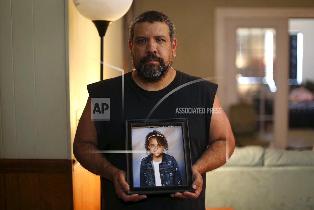 Dario Lopez-Mills Vincent Salazar holds up a framed photograph of his daughter, Layla Salazar at his home in Uvalde, Texas Thursday, May 26, 2022. Layla Salazar was one of the 19 children and their two teachers who were gunned down behind a barricaded door at Robb Elementary School. Each morning as he drove her to school in his pickup, Salazar would play "Sweet Child O' Mine," by Guns N' Roses and they'd sing along, he said. (AP Photo/Dario Lopez-Mills)