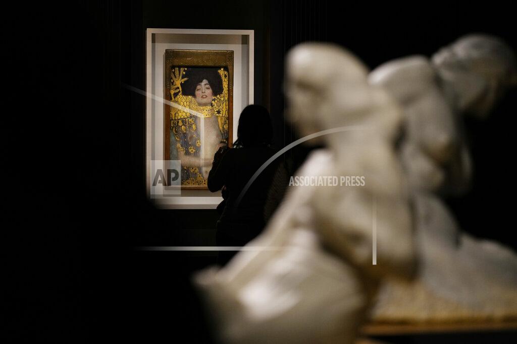 Andrew Medichini A woman admires Gustav Klimt's oil on canvas painting "Judith I" (1901) on display at the exhibition "Klimt. The Secession and Italy" at the Museum of Rome, in Palazzo Braschi, Rome, during a press preview, Tuesday, Oct. 26, 2021. The exhibition, that explores Klimt's period in Italy, will be open to visitors from Oct.27, 2021 to March 27, 2022. (AP Photo/Andrew Medichini)