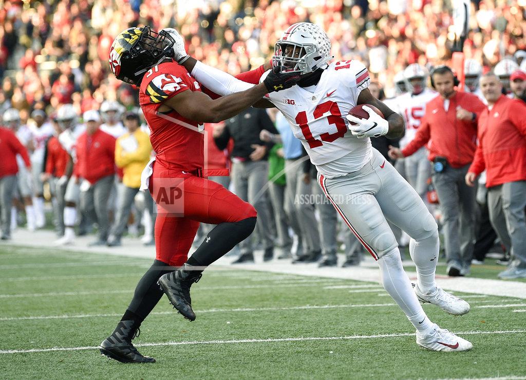 Nick Wass CORRECTS TO OVERTIME, NOT SECOND HALF - Ohio State tight end Rashod Berry (13) stiff arms Maryland linebacker Nnamdi Egbuaba (31) during overtime of an NCAA football game, Saturday, Nov. 17, 2018, in College Park, Md. Ohio State won 52-51 in overtime. (AP Photo/Nick Wass)