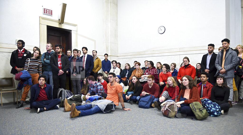Arnold Gold Students from Yale and Harvard University along with members of the Greater New Haven community charged with disorderly conduct after a protest interrupted the annual Yale Harvard football game, wait in Superior Court in New Haven, Connecticut, for their arraignments on Friday, Dec. 6, 2019. (Arnold Gold/New Haven Register via AP, Pool)