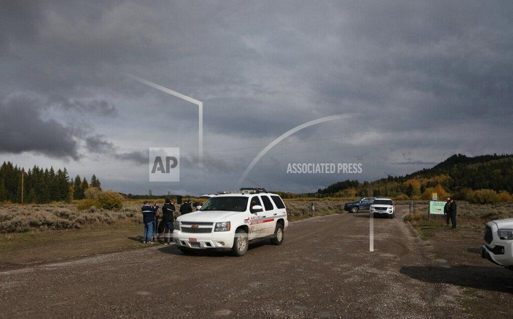 Amber Baesler A Teton County Search & Rescue vehicle drives past members of the media, left, gathered at a road blocked by U.S. Park Ranger vehicles in the Spread Creek area of the Bridger-Teton National Forest, just east of Grand Teton National Park off U.S. Highway 89, in Wyoming, Sunday, Sept. 19, 2021. Authorities say a body discovered is believed to be Gabrielle "Gabby" Petito. The FBI said the body was found by law enforcement agents who had spent the past two days searching campgrounds. (AP Photo/Amber Baesler)