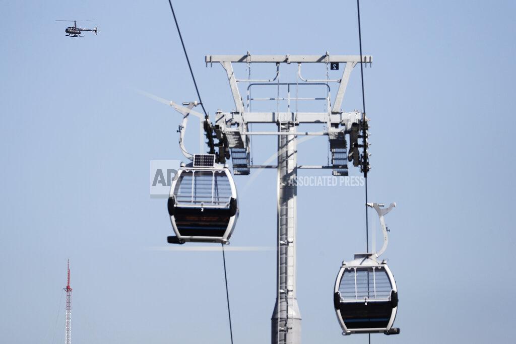 Brynn Anderson A helicopter flies by the new gondolas near the Hard Rock Stadium on Tuesday, Jan. 21, 2020, ahead of the NFL Super Bowl LIV football game in Miami Gardens, Fla. (AP Photo/Brynn Anderson)