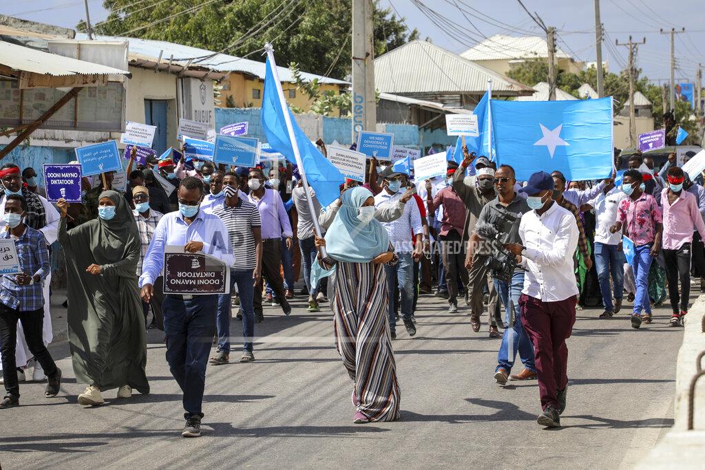 Somalis march and protest against the government and the delay of the country's election in the capital Mogadishu, Somalia Friday, Feb. 19, 2021. Security forces in Somalia's capital fired on hundreds of people protesting the delay of the country's election on Friday as at least one explosion was reported at the international airport and armored personnel carriers blocked major streets. (AP Photo)