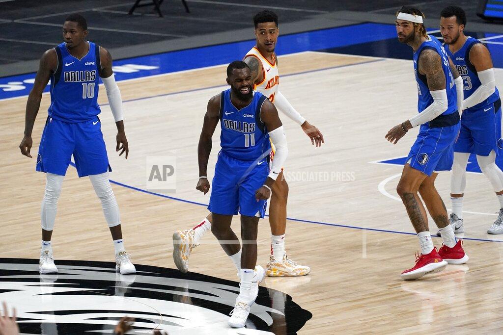 Tony Gutierrez Dallas Mavericks' Tim Hardaway Jr. (11) celebrates sinking a basket as Dorian Finney-Smith (10), Atlanta Hawks forward John Collins, center rear, Willie Cauley-Stein, second from right, and Jalen Brunson, right, look on in the second half of an NBA basketball game in Dallas, Wednesday, Feb. 10, 2021. The Mavericks won 118-117,(AP Photo/Tony Gutierrez)