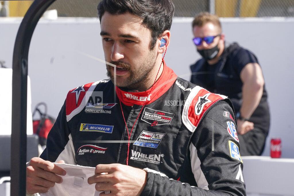 John Raoux Chase Elliott prepares himself on pit road before the start of the Rolex 24 hour auto race at Daytona International Speedway, Saturday, Jan. 30, 2021, in Daytona Beach, Fla. (AP Photo/John Raoux)