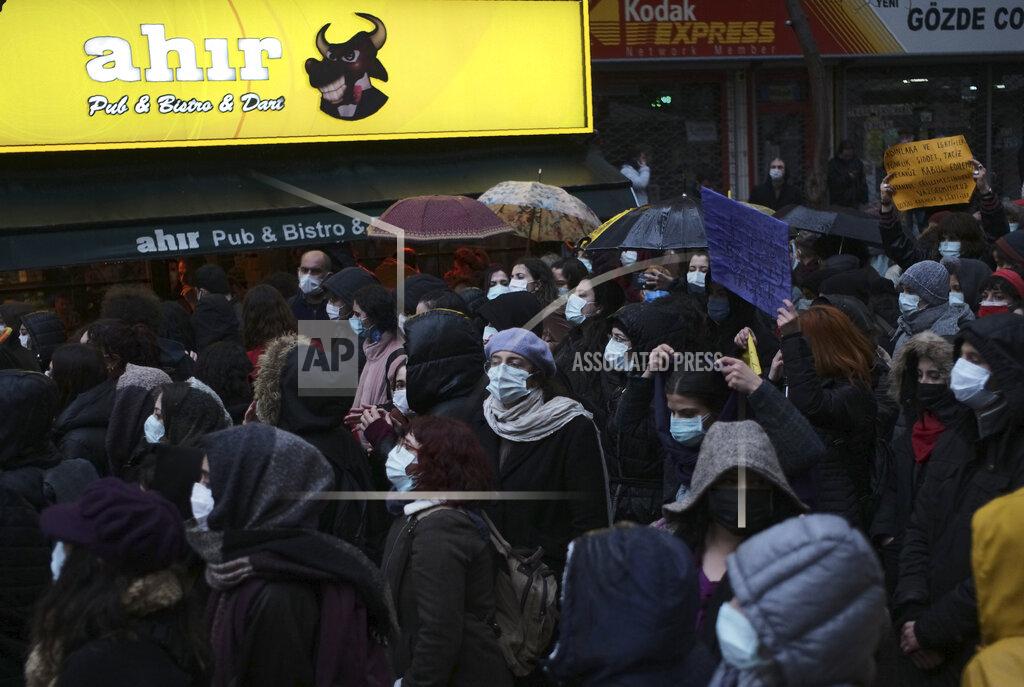 Burhan Ozbilici Women wearing masks to protect against the spread of coronavirus, walk in the rain during a women's right protest, in Ankara, Turkey, Saturday, March 20, 2021. Turkey's weekly geographic COVID-19 figures keep increasing according to Health ministry statistics released late Saturday as the country continues its "controlled normalization." (AP Photo/Burhan Ozbilici)