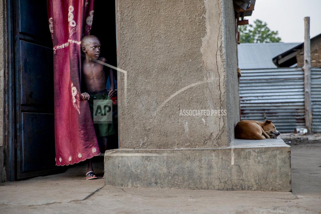 Adrienne Surprenant One of Paska Itwari Beda's child prepares for school at her Juba, South Sudan home, Wednesday, May 26, 2021. Even before the pandemic hit, South Sudanese women were accustomed to building lives on the edge of uncertainty. But COVID-19 is shaking that fragile foundation. The country is just a decade old and one of the world's most difficult places to raise children. (AP Photo/Adrienne Surprenant)