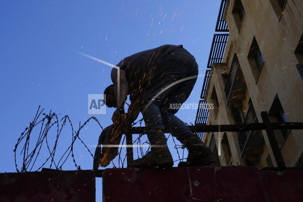 Hassan Ammar A team of engineers removes a concrete wall from a road that leads to the parliament building in Beirut, Lebanon, Monday, May 23, 2022. Lebanese authorities began removing giant cement barriers surrounding the parliament building in Beirut Monday, a week after a new legislature was elected. The blast walls were set up following nationwide protests that erupted in late 2019 amid an economic meltdown. (AP Photo/Hassan Ammar)