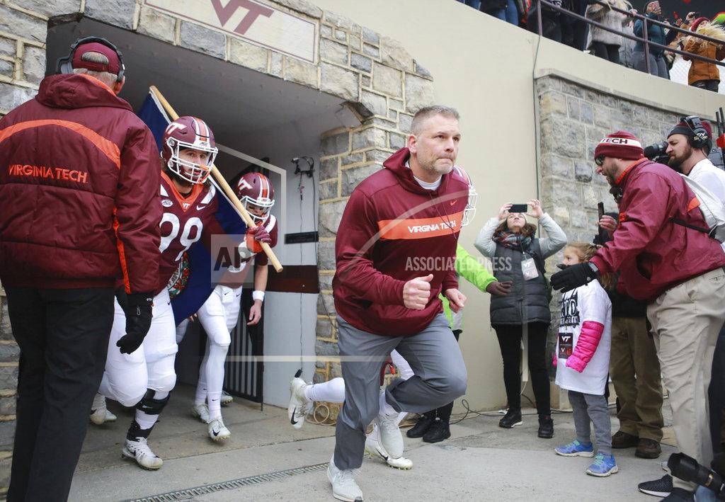 Matt Gentry Virginia Tech head coach Justin Fuente leads his team onto the field at the start of an NCAA college football game against Virginia in Blacksburg, Va., Friday, Nov. 23, 2018. (Matt Gentry/The Roanoke Times via AP)