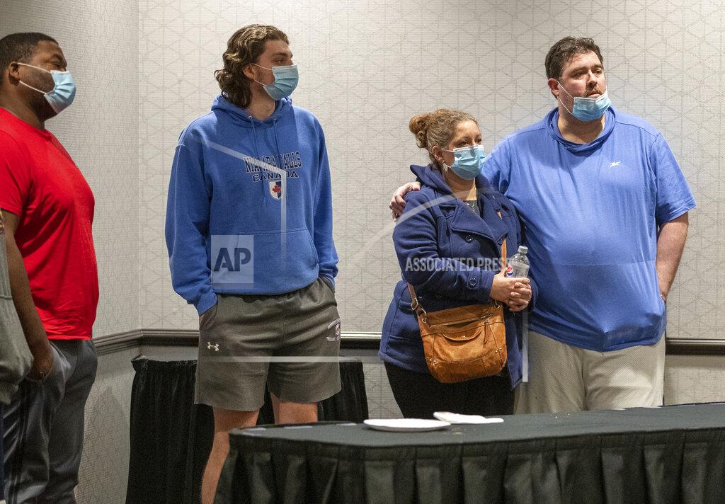 Uncredited Family members await information about their loved ones who work at the FedEx facility in Indianapolis where a mass casualty shooting occurred late Thursday, early Friday, April 16, 2021.(The Indianapolis Star via AP)