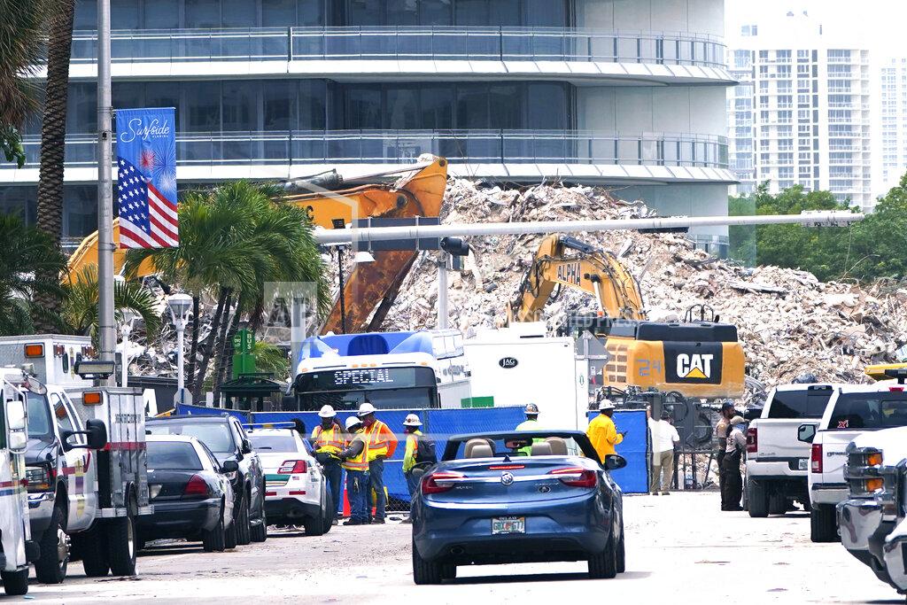 Lynne Sladky FILE - In this July 13, 2021 file photo, crews work in the rubble of the Champlain Towers South building, as removal and recovery work continues at the site of the partially collapsed condo building in Surfside, Fla. Firefighters have officially ended their search for bodies in the debris of the collapsed Surfside condo building, Friday, July 23. But police and forensic specialists continue working to identify human remains recovered from the disaster.(AP Photo/Lynne Sladky, File)