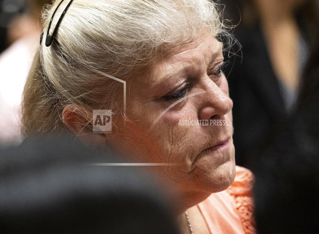 Ben Gray A tear rolls down the cheek of a woman sitting with the friends and family of victims during the plea hearing for spa shooting suspect Robert Aaron Long in Superior Court of Cherokee County in Canton, Ga. on Tuesday, July 27, 2021. The man accused of killing eight people, most of them women of Asian descent, at Atlanta-area massage businesses pleaded guilty to four of the murders. He was handed four sentences of life without parole. Robert Aaron Long still faces the death penalty in the four other deaths, which are being prosecuted in a different county. (Ben Gray/Atlanta Journal-Constitution via AP, Pool)