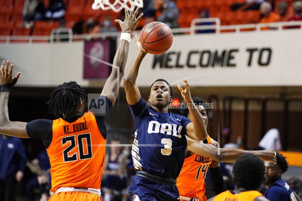 Sue Ogrocki Oral Roberts guard Max Abmas (3) shoots between Oklahoma State guard Keylan Boone (20) and guard Bryce Williams (14) during the first half of an NCAA college basketball game Tuesday, Dec. 8, 2020, in Stillwater, Okla. (AP Photo/Sue Ogrocki)