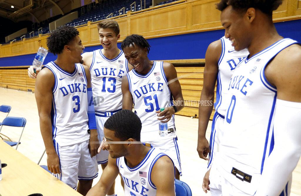 Ethan Hyman Duke's Tre Jones (3) laughs with Joey Baker (13), Mike Buckmire (51), Cassius Stanley (2), bottom left, and Wendell Moore (0) during an NCAA college basketball media day at Cameron Indoor Stadium in Durham, N.C., Monday, Sept. 23, 2019. (Ethan Hyman/The News & Observer via AP)