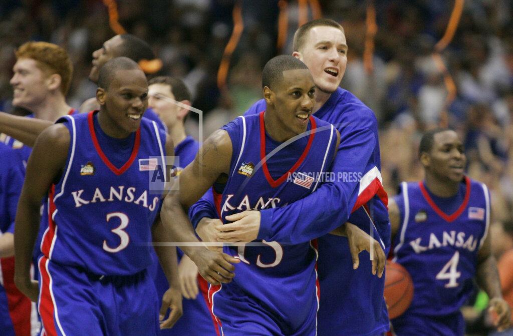 Eric Gay FILE - In this April 7, 2008, file photo, Kansas players Russell Robinson (3), Mario Chalmers (15) Brady Morningstar, rear, and Sherron Collins, right, celebrate their 75-68 victory over Memphis in the NCAA college basketball Final Four in San Antonio. (AP Photo/Eric Gay, File)