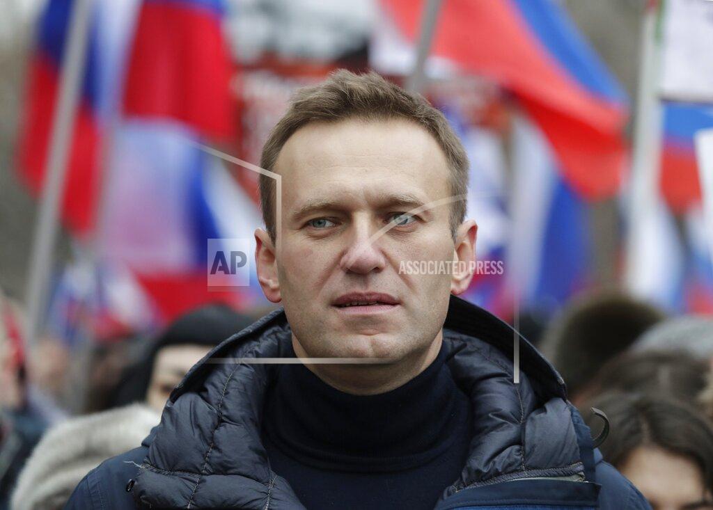 Pavel Golovkin FILE - In this Sunday, Feb. 24, 2019 file photo, Russian opposition activist Alexei Navalny takes part in a march in memory of opposition leader Boris Nemtsov in Moscow, Russia. Russian opposition politician Alexei Navalny was placed on a ventilator in a hospital intensive care unit in Siberia after falling ill from suspected poisoning during a flight, his spokeswoman said Thursday Aug. 20, 2020. (AP Photo/Pavel Golovkin, File)