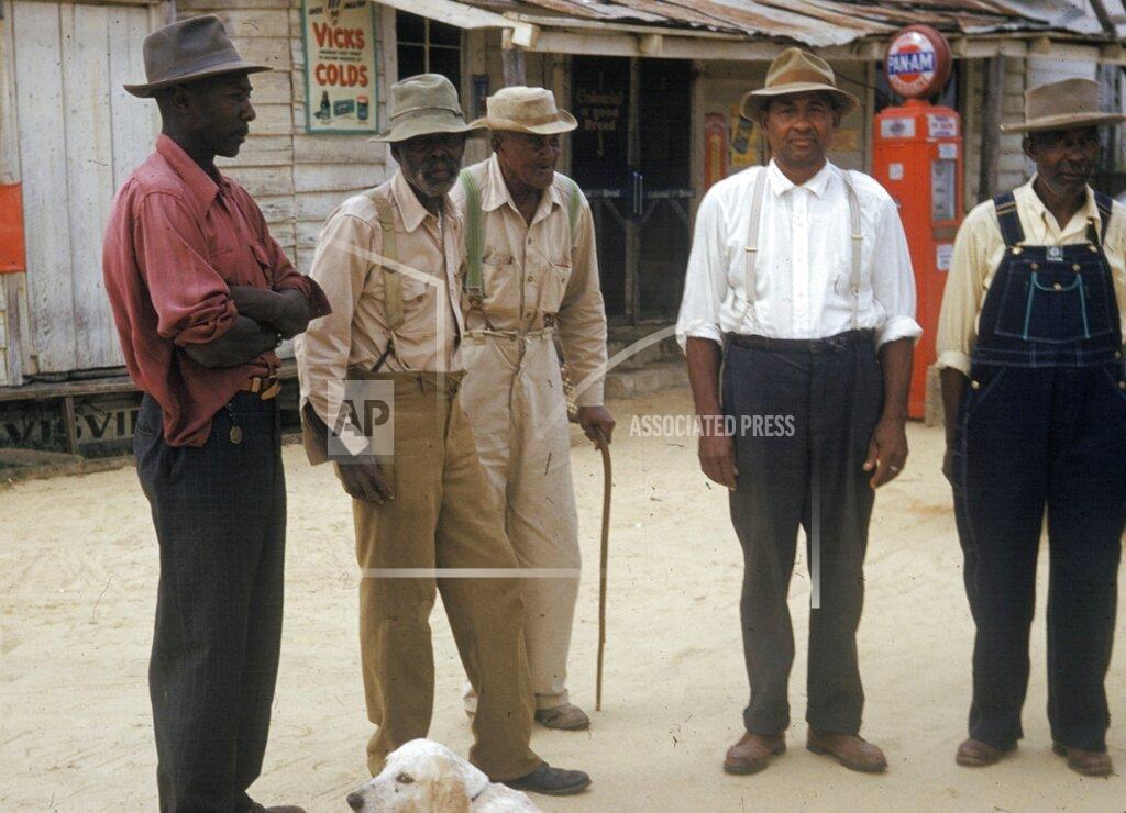 Uncredited FILE - In this 1950's file photo released by the National Archives, men included in a syphilis study pose for a photo in Tuskegee, Ala. Historic failures in government response to disasters and emergencies, medical abuse, neglect and exploitation have jaded generations of black people into a distrust of public institutions. Some might call it the Tuskegee effect, referring to the U.S. government’s once-secret syphilis study of black men in Alabama that one study shows later reduced their life expectancy due to distrust of medical science. (National Archives via AP, File)