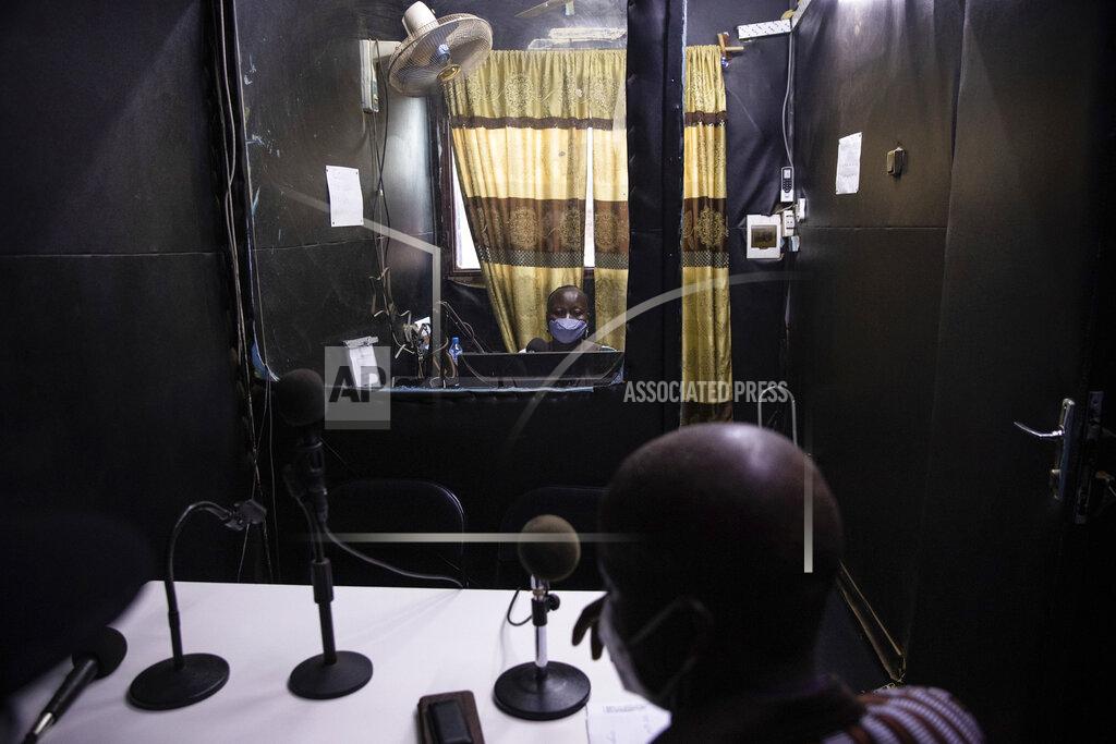 Sophie Garcia Mariama Sawadogo, 44, works as a radio host at Zama Radio, in Kaya, Burkina Faso, Monday, Oct. 25, 2021. Many guests and listeners in Burkina Faso call her "aunty" as she gently guides them to the right answers and awards prizes such as soap and washing buckets. In the West African country of Burkina Faso, many feel the government has let them down during the pandemic. Tests, vaccines and messaging often miss many residents, despite a $200 million budget for virus-response efforts. In a region where women are responsible for family work and community relationships, they’ve stepped up to fill in gaps. (AP Photo/Sophie Garcia)