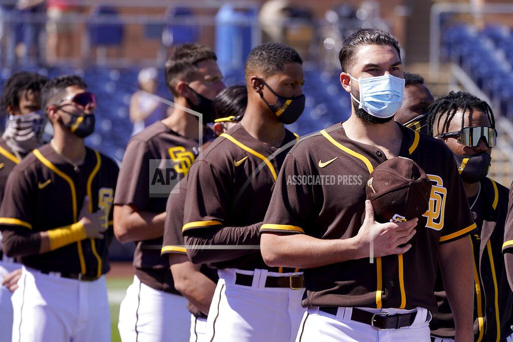 Charlie Riedel Players for the San Diego Padres stand for the national anthem before a spring training baseball game against the Chicago Cubs, Monday, March 1, 2021, in Peoria, Ariz. (AP Photo/Charlie Riedel)