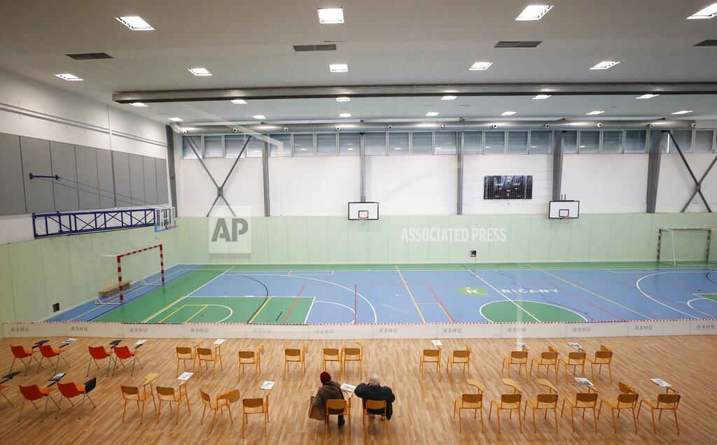 Petr David Josek Elderly residents sit and wait after receiving Moderna COVID-19 vaccine at a sports hall in Ricany, Czech Republic, Friday, Feb. 26, 2021. With new infections soaring due to a highly contagious coronavirus variant and hospitals filling up, one of the hardest-hit countries in the European Union is facing inevitable: a tighter lockdown. (AP Photo/Petr David Josek)