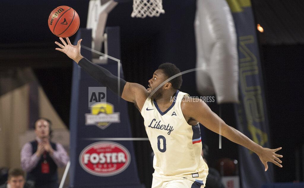 Lee Luther Jr. Liberty forward Myo Baxter-Bell grabs a one-handed rebound against Lipscomb during the first half of the Atlantic Sun conference NCAA basketball championship game in Lynchburg, Va., Sunday, March 8, 2020. (AP Photo/Lee Luther Jr.)