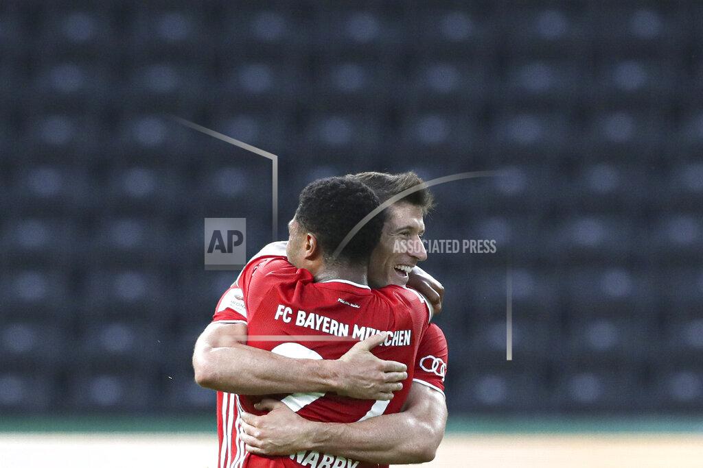 Michael Sohn Bayern's Robert Lewandowski, right, celebrates after scoring his side's third goal with teammate Serge Gnabry during the German soccer cup (DFB Pokal) final match between Bayer 04 Leverkusen and FC Bayern Munich in Berlin, Germany, Saturday, July 4, 2020. (AP Photo/Michael Sohn)