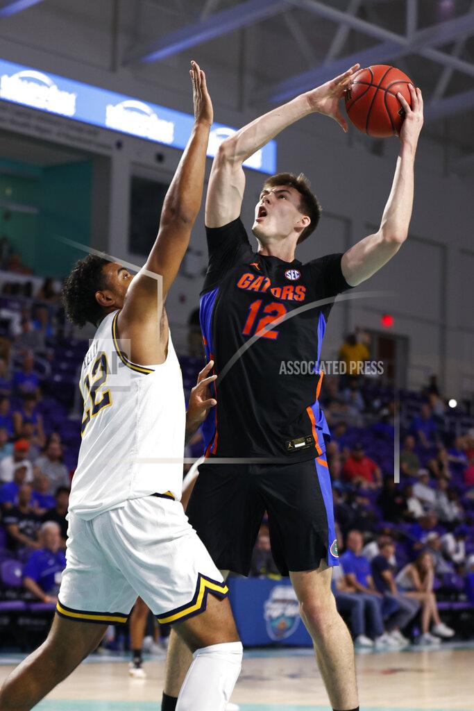 Scott Audette Florida forward Colin Castleton (12) drives to the basket past California forward Andre Kelly (22) during the first half of an NCAA college basketball game on Monday, Nov. 22, 2021, in Fort Myers, Fla. (AP Photo/Scott Audette)