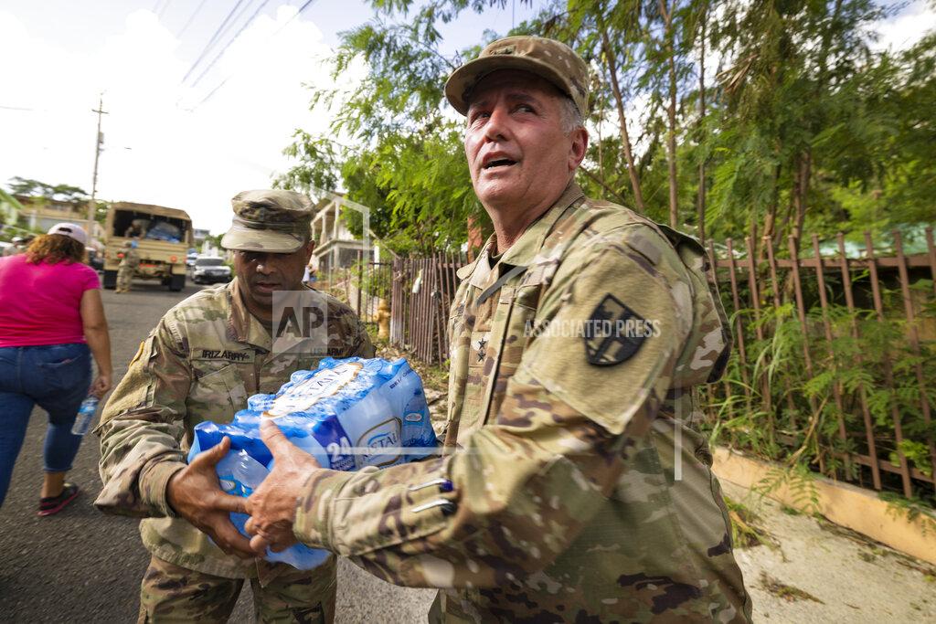 Alejandro Granadillo Members of the National Guard deliver water to the residents of Punta Diamante in Ponce, Puerto Rico, Wednesday, September 21, 2022.(AP Photo/Alejandro Granadillo)