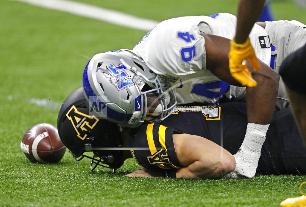 Gerald Herbert Middle Tennessee defensive end Tyshun Render (94) covers Appalachian State quarterback Zac Thomas (12) after Thomas fumbled, which Middle Tennessee recovered, in the first half of the New Orleans Bowl NCAA college football game in New Orleans, Saturday, Dec. 15, 2018. (AP Photo/Gerald Herbert)