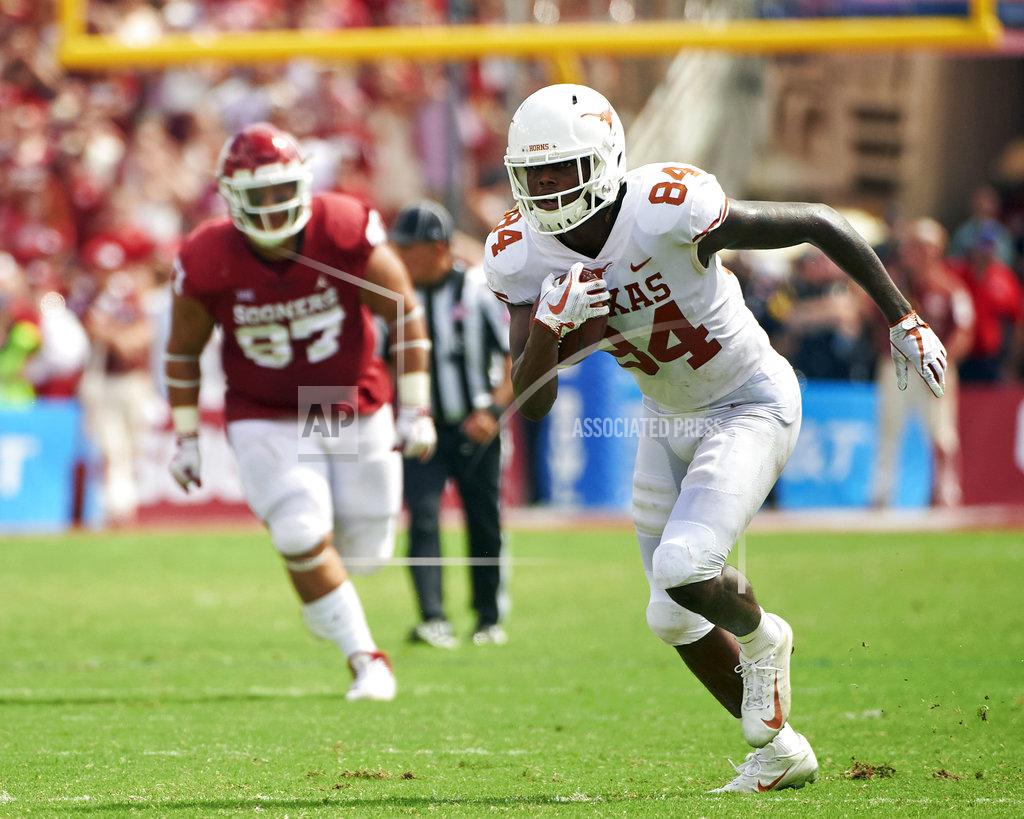 Cooper Neill FILE - In this Saturday, Oct. 6, 2018, file photo, Texas wide receiver Lil'Jordan Humphrey (84) breaks free against Oklahoma during the second half of an NCAA college football game at the Cotton Bowl in Dallas. Humphrey and Collin Johnson have been a big problem for opposing defenses. The duo has combined for 65 catches and eight touchdowns for the No. 9 Longhorns. (AP Photo/Cooper Neill, File)
