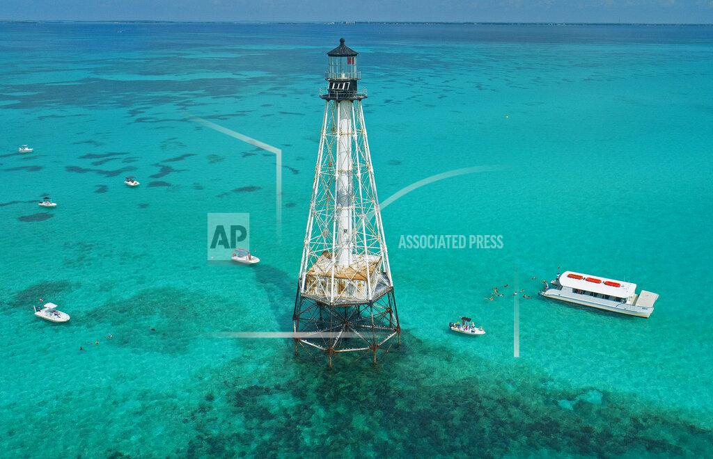 Andy Newman This aerial photo provided by the Florida Keys News Bureau shows boats with snorkelers anchored around Alligator Reef Lighthouse, Tuesday, Sept. 7, 2021, off Islamorada, Fla., in the Florida Keys. On Tuesday, officials from the Islamorada-based Friends of the Pool, Inc., announced that U.S. Secretary of the Interior Deb Haaland approved a recommendation from the National Park Service that the organization be granted ownership of the lighthouse under the National Historic Lighthouse Preservation Act. Friends of the Pool hopes to raise about $9 million to preserve the almost 150-year-old structure. (Andy Newman/Florida Keys News Bureau via AP)