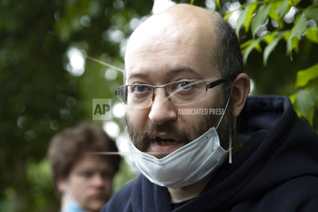 Alexander Zemlianichenko Prominent Russian journalist Ilya Azar, who was sentenced for holding a one-person protest amid lockdown, speaks to the media shortly after his release in Moscow, Russia, Sunday, June 7, 2020. A Russian journalist whose jailing prompted protests in which police detained demonstrators has been released. The detentions brought criticism that authorities were using coronavirus restrictions to suppress opposition. Ilya Azar was sentenced to 15 days in jail on May 28, but was released Sunday after a court reduced his sentence. Azar was arrested after holding a one-man picket outside police headquarters in Moscow against the jailing on extortion charges of an activist who monitors police corruption. (AP Photo/Alexander Zemlianichenko)