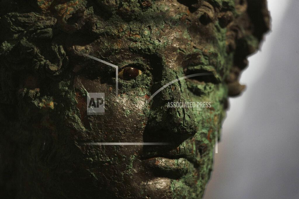 Gregorio Borgia A Dionysus bust is displayed at the museum Antiquarium, in Pompeii, southern Italy, Monday, Jan. 25, 2021. Decades after suffering bombing and earthquake damage, Pompeii's museum is back in business, showing off exquisite finds from excavations of the ancient Roman city. Officials of the archaeological park of the ruins of the city destroyed in 79 A.D. by the eruption of Mount Vesuvius inaugurated the museum on Monday. (AP Photo/Gregorio Borgia)