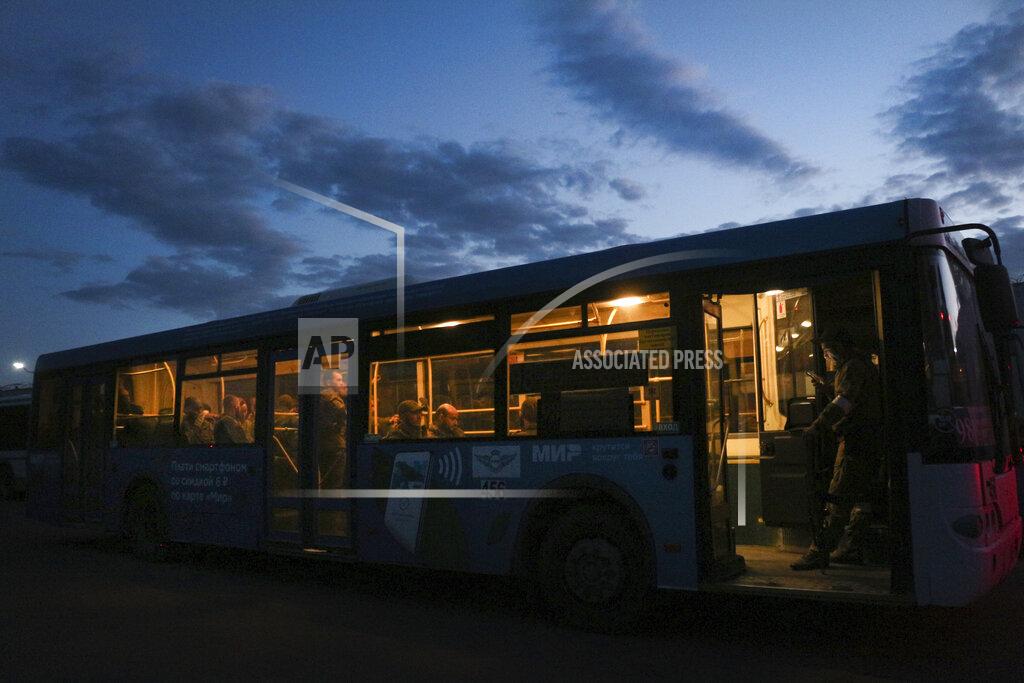 Uncredited Ukrainian servicemen sit in a bus after they were evacuated from the besieged Mariupol's Azovstal steel plant, near a prison in Olyonivka, in territory under the government of the Donetsk People's Republic, eastern Ukraine, Tuesday, May 17, 2022. More than 260 fighters, some severely wounded, were pulled from a steel plant on Monday that is the last redoubt of Ukrainian fighters in the city and transported to two towns controlled by separatists, officials on both sides said. (AP Photo)