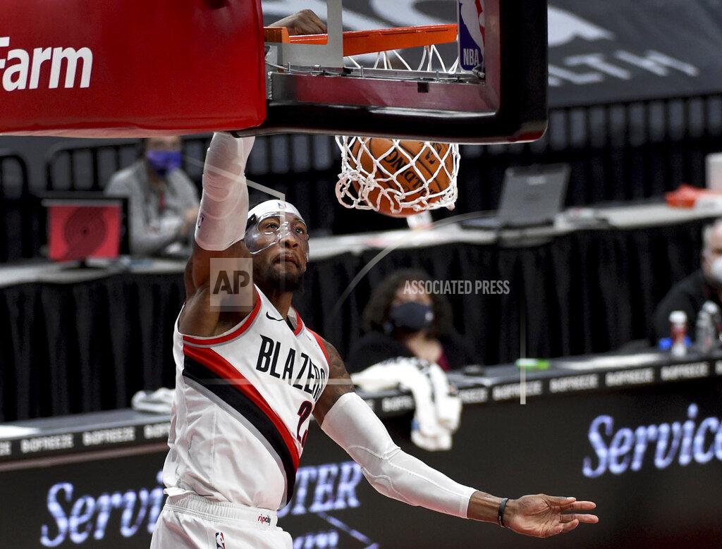 Steve Dykes Portland Trail Blazers forward Robert Covington dunks during the first half of the team's NBA basketball game against the Dallas Mavericks in Portland, Ore., Friday, March 19, 2021. AP Photo/Steve Dykes)