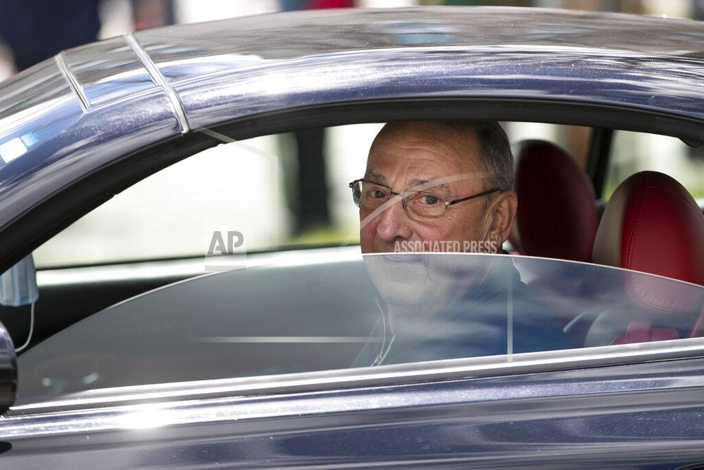 Robert F. Bukaty Former Gov. Paul LePage, sitting in a Lexus SC 430, talks to supporters at a rally against the executive orders by Gov. Janet Mills to keep some Maine businesses closed to help prevent the spread of coronavirus, Saturday, May 16, 2020, in Augusta, Maine. LePage, now a resident of Florida, stayed in his car parked near the rally. A speaker at the event said the former governor was quarantining. (AP Photo/Robert F. Bukaty)