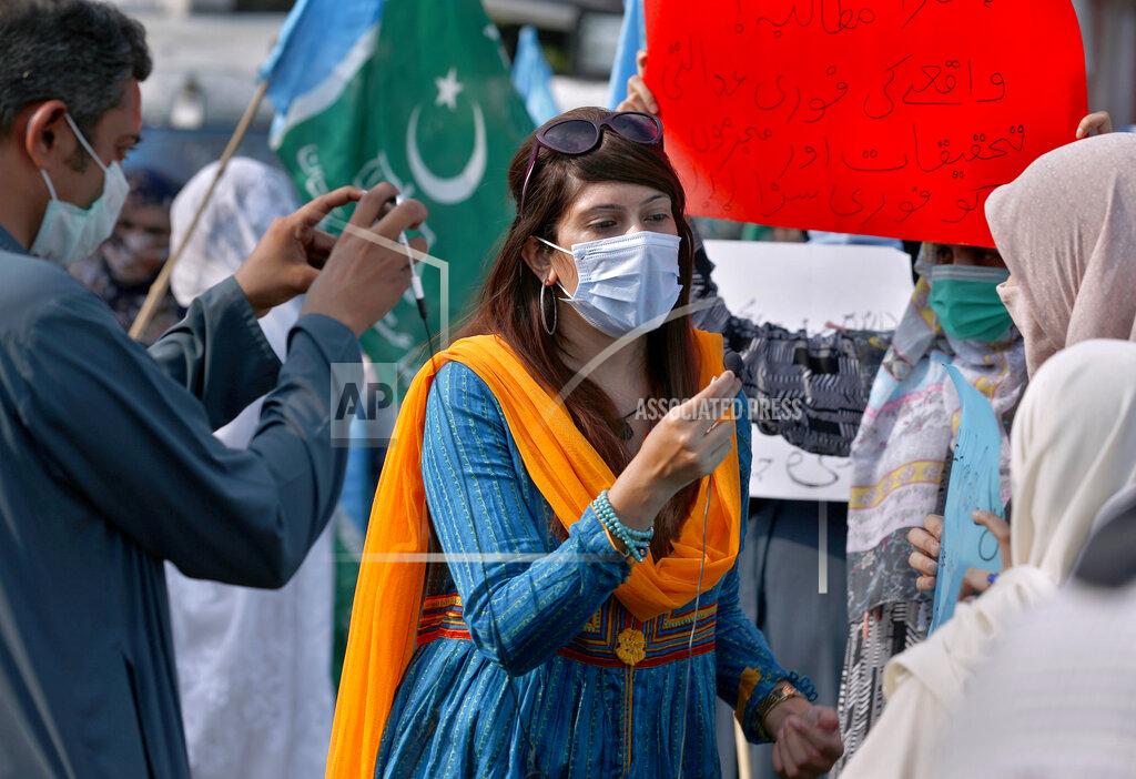 Anjum Naveed In this Friday, Sept. 11, 2020 photo, Mona Khan, a freelance female journalist, interviews during a rally, in Islamabad, Pakistan. Social media attacks against Pakistan's women journalists have been vile and vicious, some threatening rape, others even threatening death and the culprits are most often allied to the ruling party, even prompting the Committee to Protect Journalists to issue a statement on Friday, Sept. 18, condemning the relentless attacks. (AP Photo/Anjum Naveed)