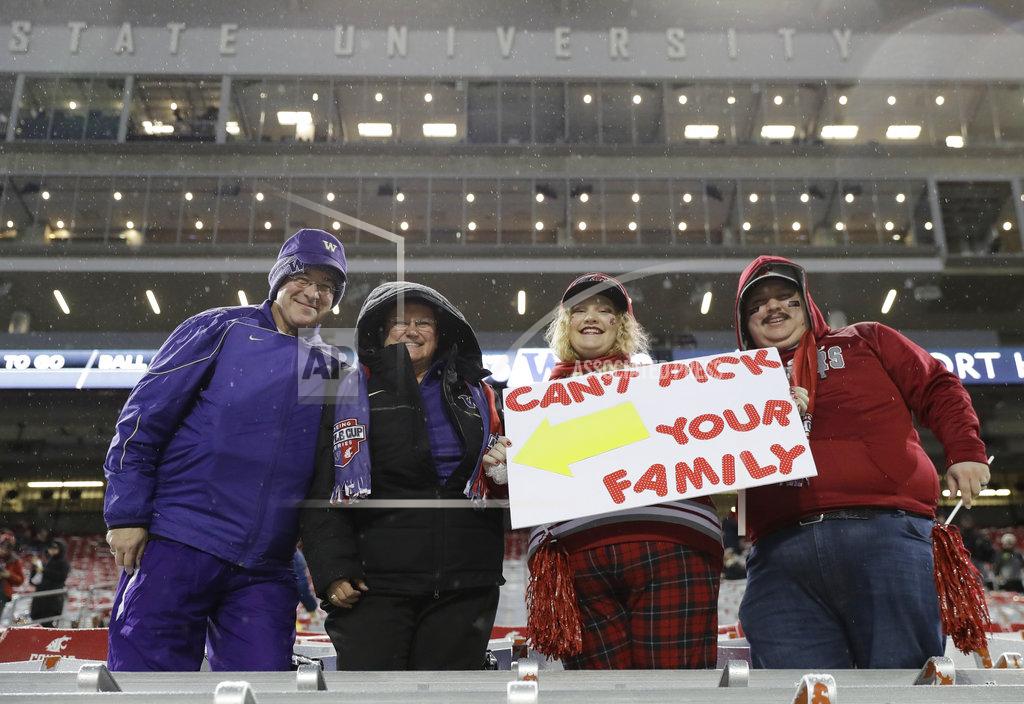 Ted S. Warren Washington and Washington State fans display their divided family loyalties as they wait in the stands before the Apple Cup NCAA college football game between cross-state rivals Washington and Washington State, Friday, Nov. 23, 2018, in Pullman, Wash. (AP Photo/Ted S. Warren)