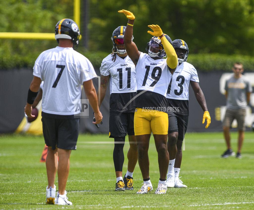 Steve Mellon Pittsburgh Steelers wide receiver Juju Smith-Schuster mimics a basketball shot during the NFL football team's training camp in Pittsburgh on Friday, July 23, 2021. With him are quarterback Ben Roethlisberger (7), and wide receivers Chase Claypool (11) and James Washington (13). (Steve Mellon/Pittsburgh Post-Gazette via AP)
