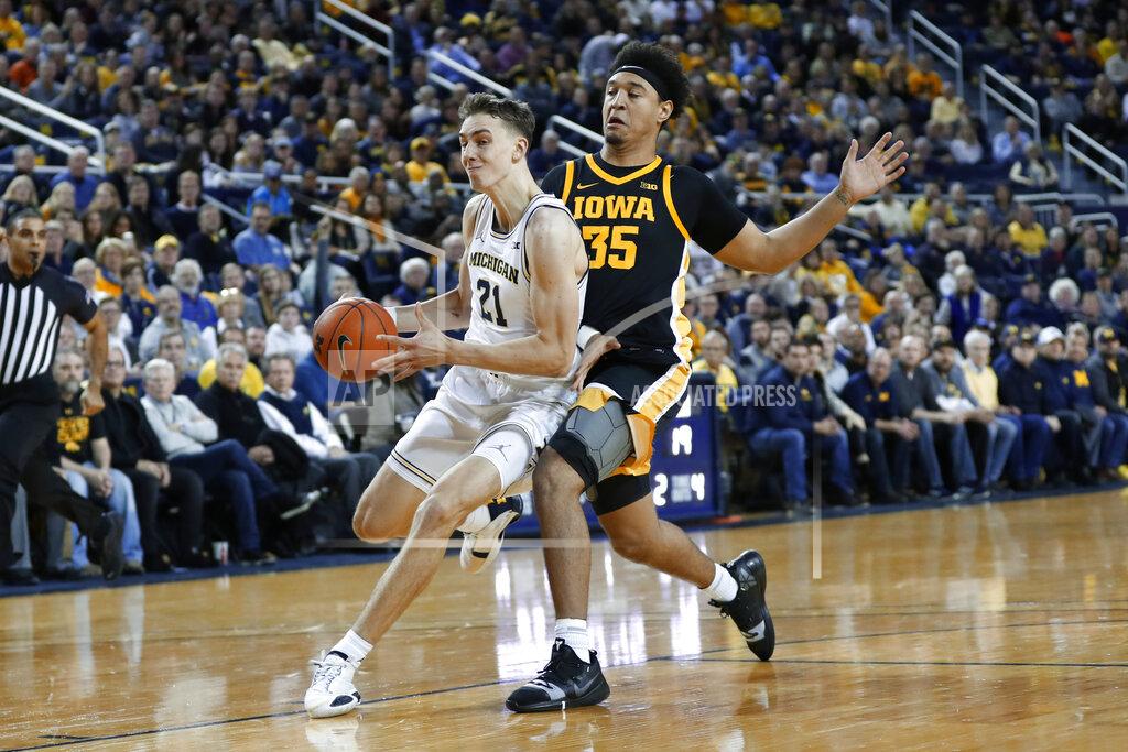 Paul Sancya Michigan guard Franz Wagner (21) drives against Iowa forward Cordell Pemsl (35) in the first half of an NCAA college basketball game in Ann Arbor, Mich., Friday, Dec. 6, 2019. (AP Photo/Paul Sancya)