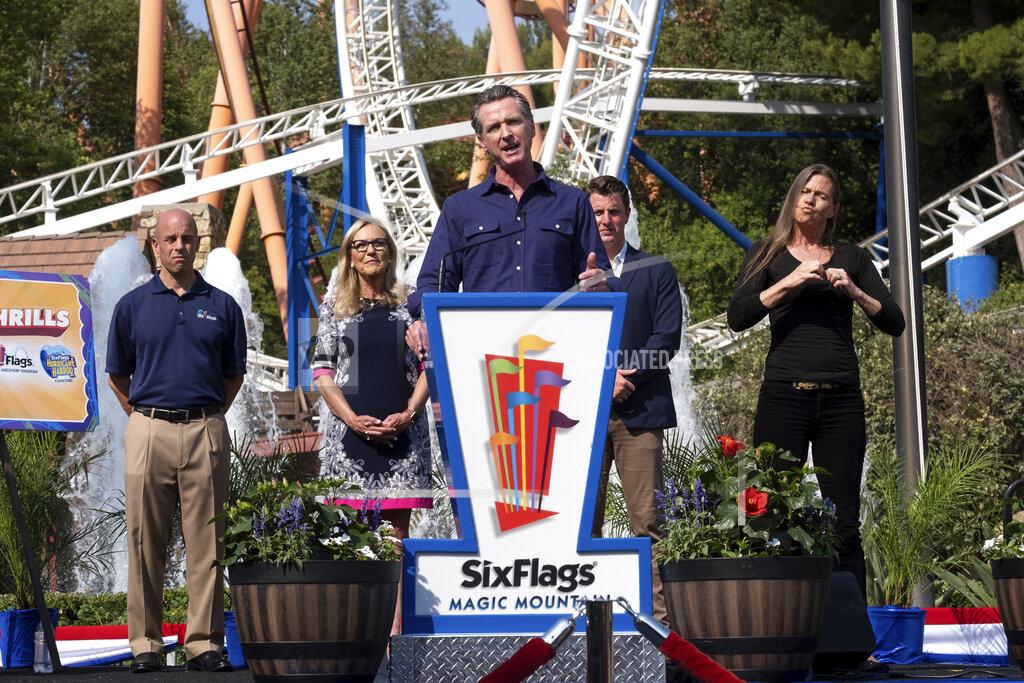 David Crane California Gov. Gavin Newsom welcomes the public to Six Flags Magic Mountain in Santa Clarita, Calif. on Wednesday, June 16, 2021. In the background, from left, are; Michael Spanos, President of Six Flags, LA county supervisor Kathryn Barger and state senator Henry Stern. Newsom continued his tour of the state after lifting most COVID-19 restrictions Tuesday. (David Crane/The Orange County Register via AP)