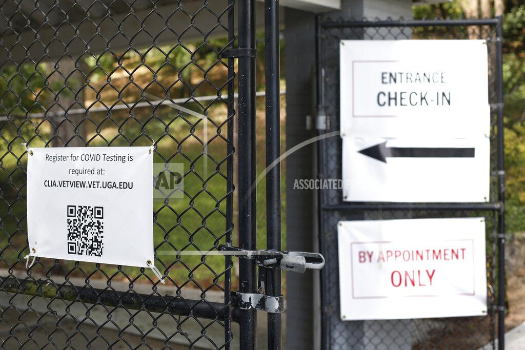 Joshua L. Jones Signs mark the entrance to the University of Georgia's COVID-19 testing site in Athens, Ga, on Thursday, Sept. 3, 2020. (Joshua L. Jones/Athens Banner-Herald via AP)