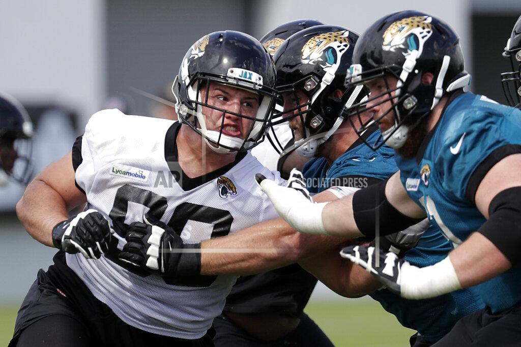 FILE - In this June 11, 2019, file photo, Jacksonville Jaguars defensive tackle Taven Bryan, left, rushes the offensive line during an NFL football practice, in Jacksonville, Fla. The defensive tackle and 2018 first-round draft pick is expected to be in the starting lineup again Thursday night, Aug. 29, 2019, when the Jaguars (0-3) host the Atlanta Falcons (0-4) in the preseason finale for both teams. (AP Photo/John Raoux, File)