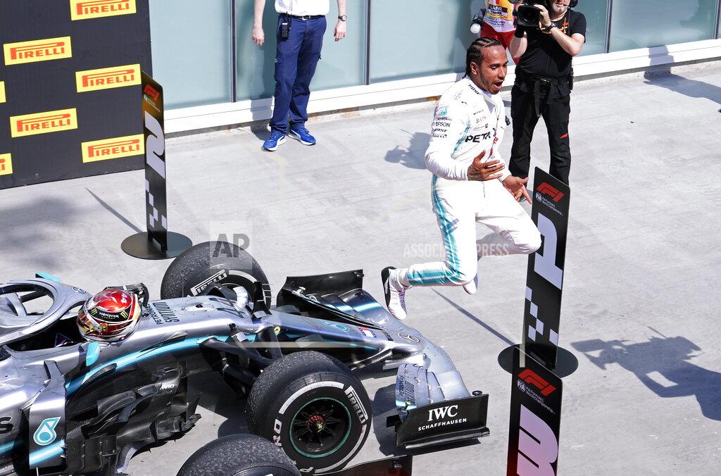Paul Chiasson Mercedes driver Lewis Hamilton, of Britain, celebrates after winning Formula One Canadian Grand Prix auto race in Montreal, Sunday, June 9, 2019. (Paul Chiasson/The Canadian Press via AP)