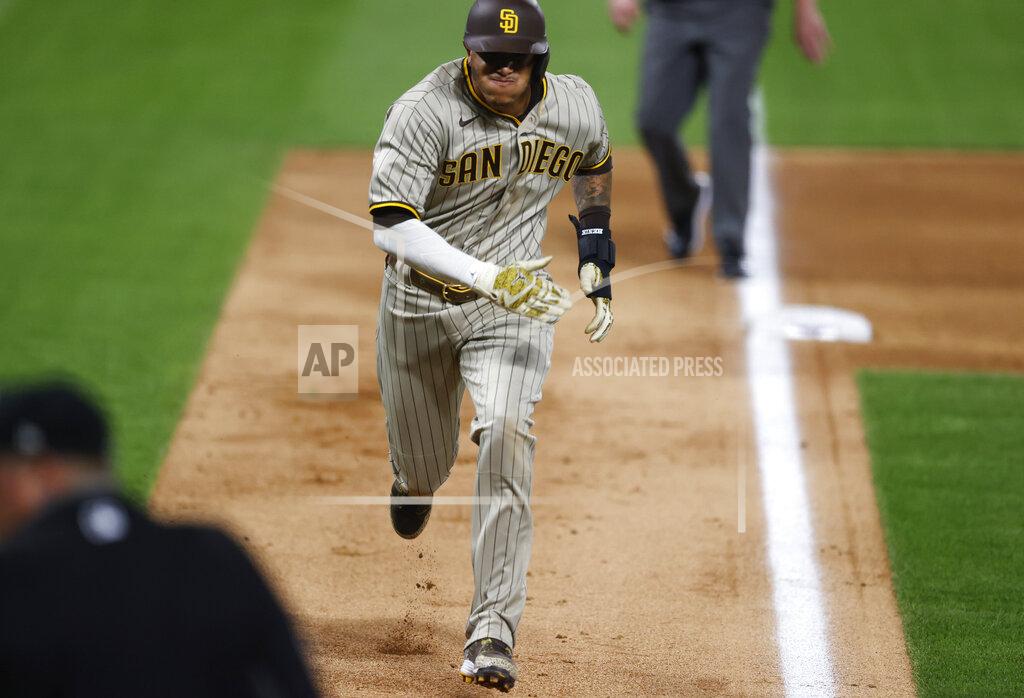 David Zalubowski San Diego Padres' Manny Machado advances from third base to score on a passed ball against the Colorado Rockies in the sixth inning of a baseball game Friday, July 31, 2020, in Denver. (AP Photo/David Zalubowski)